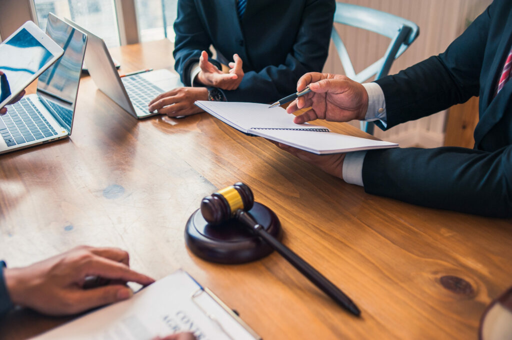 Lawyers at a meeting discussing strategy for client's case.