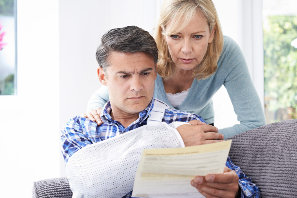 Injured person reviewing documents with his spouse.